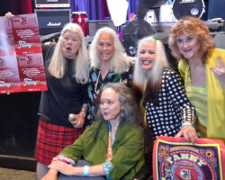 Fanny posing for the press after the concert. L-R: Alice de Buhr (drums), June Millington (guitar), Brie Howard Darling (drums), Patti Quatro (guitar), and Jean Millington (vocals) is seated in her wheelchair.