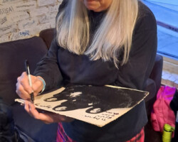 Alice de Buhr dressed up in her kilt signs my album cover for me. And no, she did not go commando under her kilt. You don't play drums in a kilt without underwear.